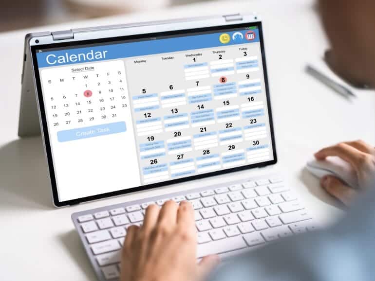 5-arrange-installation-770x433 Person scheduling solar panel installation on a digital calendar.