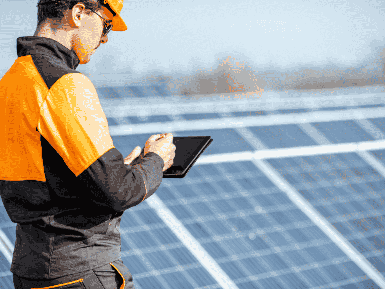 6-aftercare-770x433 Solar panel technician inspecting solar panels with tablet in outdoor setting.